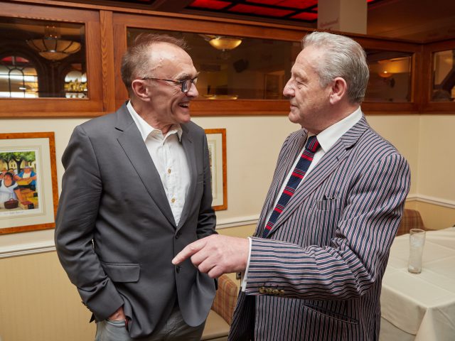Rodney Scott, co-owner of the Pier Hotel, enjoys a joke with film director Danny Boyle.
